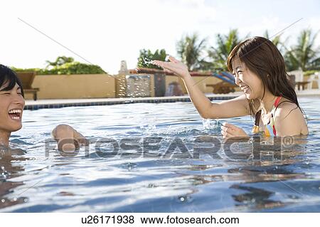 Couple playing in swimming pool, Saipan View Large Photo Image Stock Photo - Couple playing in swimming pool, Saipan. Fotosearch
