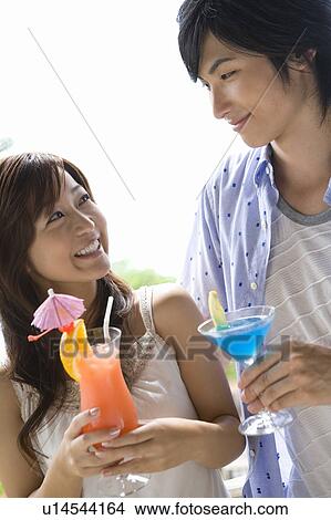 Picture - Young couple drinking cocktail, Saipan. Fotosearch