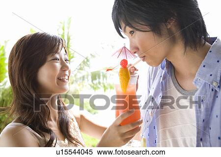 Young couple drinking cocktail, Saipan View Large Photo Image Stock Photography - Young couple drinking cocktail, Saipan. Fotosearch