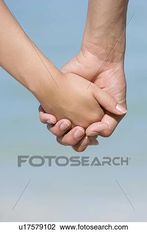 Young couple on beach, hand in hand, Saipan, USA View Large Photo Image Stock Image - Young couple on beach, hand in hand, Saipan, USA . Fotosearch