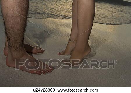 Young couple on beach, woman standing on toes, Saipan, USA View Large Photo Image Stock Photo - Young couple on beach, woman standing on toes, Saipan, USA . Fotosearch