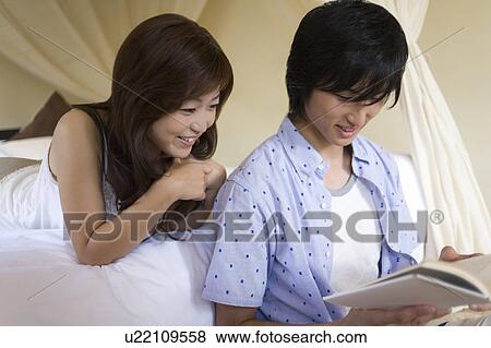 Young couple reading a book, Saipan View Large Photo Image Stock Photo - Young couple reading a book, Saipan. Fotosearch
