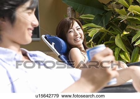 Young couple relaxing at balcony, Saipan, Differential Focus View Large Photo Image Stock Photo - Young couple relaxing at balcony, Saipan, Differential Focus. Fotosearch
