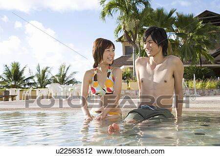 Young couple sitting by the swimming pool, Saipan View Large Photo Image Stock Image - Young couple sitting by the swimming pool, Saipan. Fotosearch