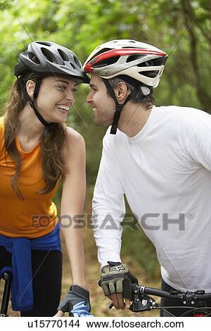 Picture - Couple with bicycles looking at each other. Fotosearch
