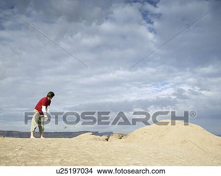 Man playing golf at rock strata View Large Photo Image Picture - Man playing golf at rock strata. Fotosearch