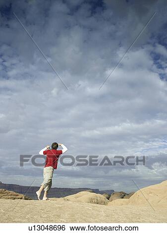 Man playing golf at rock strata View Large Photo Image Stock Photograph - Man playing golf at rock strata. Fotosearch