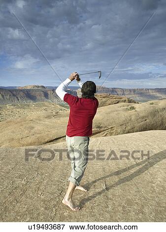 Man playing golf in desert, rear view View Large Photo Image Stock Photo - Man playing golf in desert, rear view. Fotosearch
