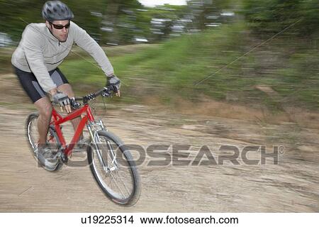Man riding mountain bike, blurred motion View Large Photo Image Picture - Man riding mountain bike, blurred motion. Fotosearch