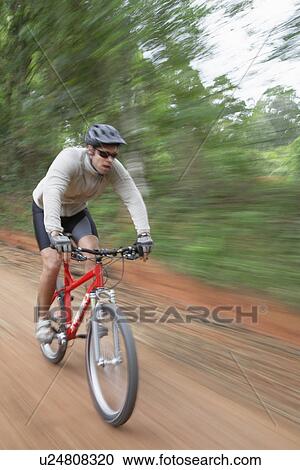 Man riding mountain bike, blurred motion View Large Photo Image Stock Image - Man riding mountain bike, blurred motion. Fotosearch
