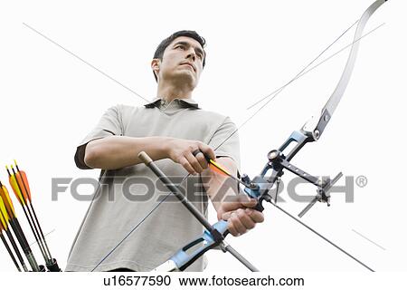 Mid adult man with bow and arrow (low angle view) View Large Photo Image Stock Image - Mid adult man with bow and arrow (low angle view). Fotosearch