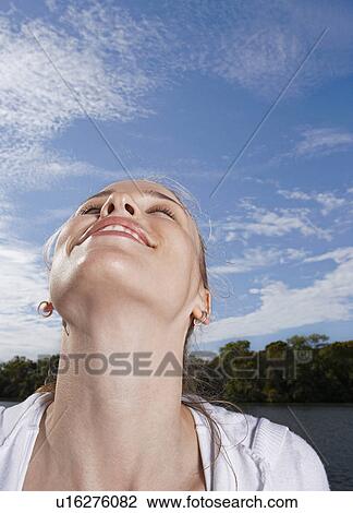 Stock Image - Mid Adult Woman with Head Back. Fotosearch