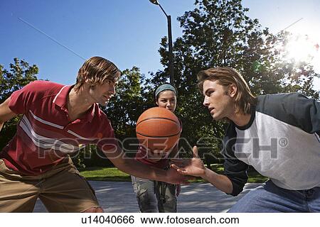 Three People Playing Basketball View Large Photo Image Stock Photograph - Three People Playing Basketball. Fotosearch
