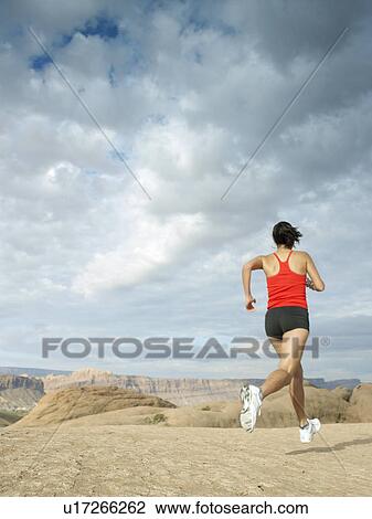 Woman jogging in desert View Large Photo Image Stock Image - Woman jogging in desert. Fotosearch