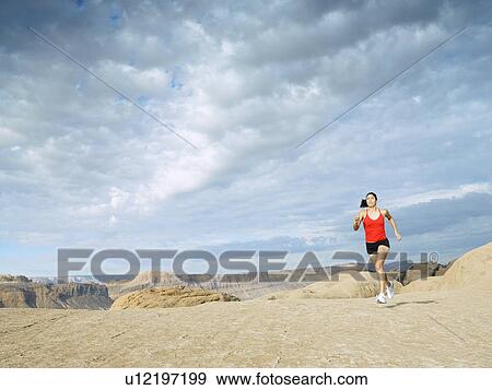 Woman jogging in desert View Large Photo Image Stock Photo - Woman jogging in desert. Fotosearch