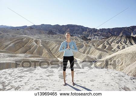 Young woman doing yoga in desert, Death Valley, California, USA View Large Photo Image Stock Photography - Young woman doing yoga in desert, Death Valley, California, USA. Fotosearch