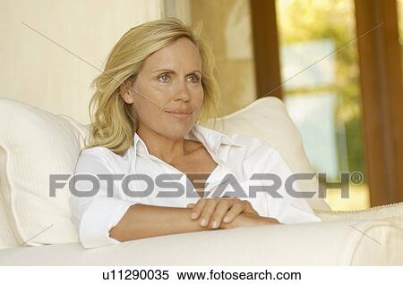 Mature woman in white shirt on armchair View Large Photo Image Stock Photography - Mature woman in white shirt on armchair. Fotosearch