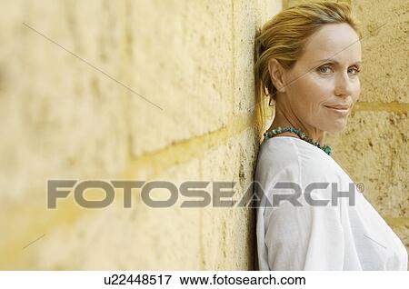 Mature woman leaning on brick wall (portrait) View Large Photo Image Stock Photo - Mature woman leaning on brick wall (portrait). Fotosearch