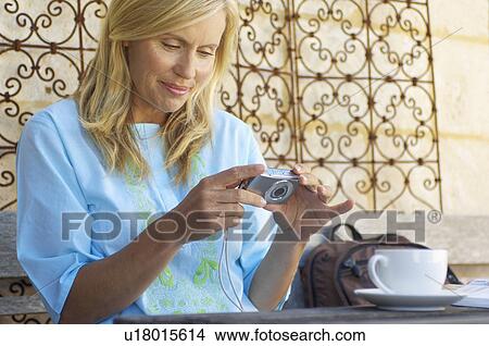 Mature woman with digital camera View Large Photo Image Picture - Mature woman with digital camera. Fotosearch