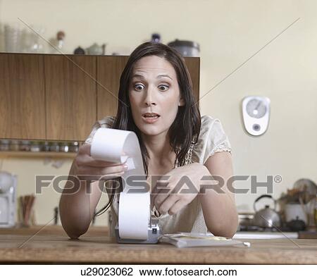 Mid-Adult Woman Examining Receipts View Large Photo Image Stock Image - Mid-Adult Woman Examining Receipts. Fotosearch