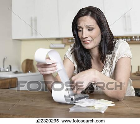 Mid-Adult Woman Examining Receipts View Large Photo Image Stock Photography - Mid-Adult Woman Examining Receipts. Fotosearch