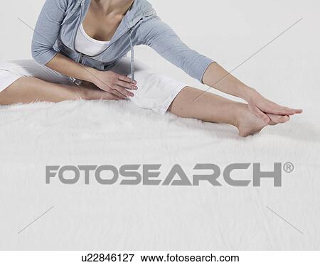 Stock Photo - Mid-Adult Woman Stretching. Fotosearch