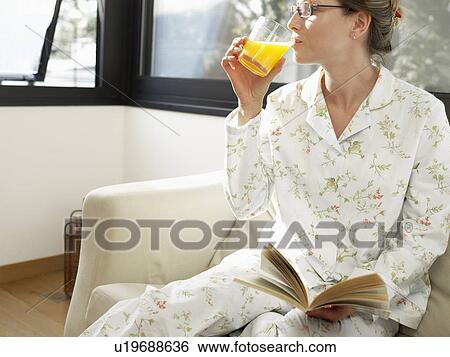 Young woman in pajama drinking orange juice View Large Photo Image Stock Photograph - Young woman in pajama drinking orange juice. Fotosearch