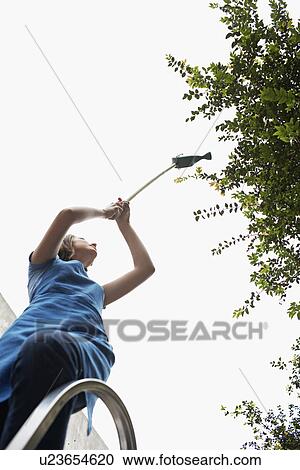 Female Florist on Step Ladder Watering Plants View Large Photo Image Stock Image - Female Florist on Step Ladder Watering Plants. Fotosearch
