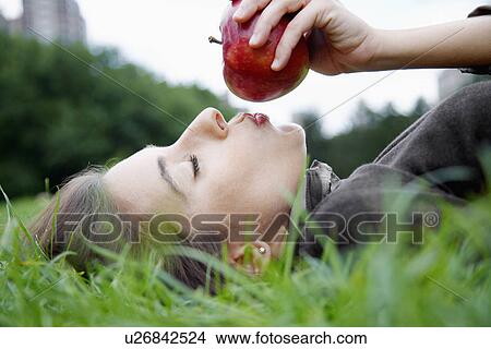 Picture - Woman kissing apple. Fotosearch