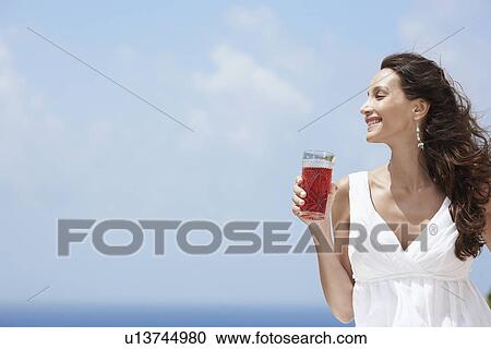 Young woman having juice View Large Photo Image Stock Image - Young woman having juice. Fotosearch