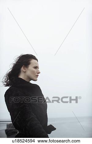 Young woman in fur coat looking at view View Large Photo Image Picture - Young woman in fur coat looking at view. Fotosearch