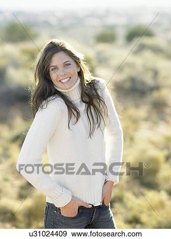 Stock Photo - Young woman in white turtleneck, portrait. Fotosearch