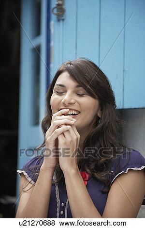 Young woman laughing with eyes closed View Large Photo Image Stock Photo - Young woman laughing with eyes closed. Fotosearch