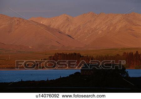 Stock Image - Red Mountains Above River. Fotosearch