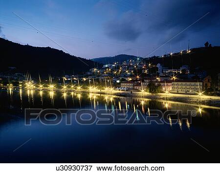 Stock Photo - Town By Lake At Night. Fotosearch