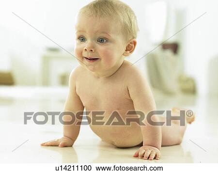 Stock Image - Baby crawling and smiling. Fotosearch