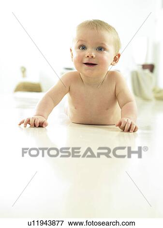 Stock Photo - Baby crawling and smiling. Fotosearch
