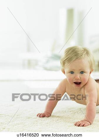 Stock Image - Baby crawling indoors. Fotosearch