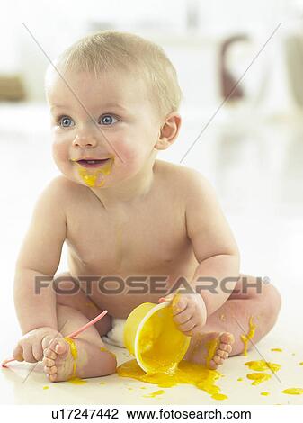 Stock Image - Baby eating and making mess. Fotosearch