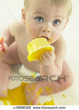 Stock Photograph - Baby eating and making mess. Fotosearch
