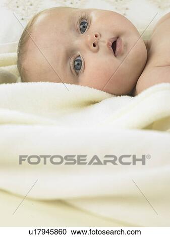 Stock Image - Baby laying on a towel. Fotosearch