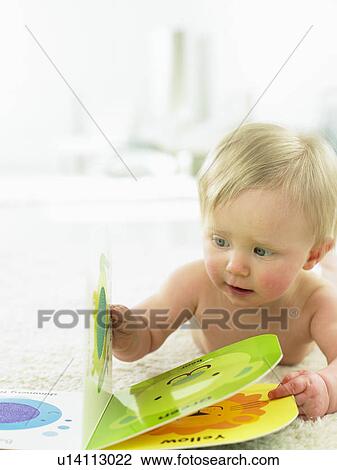 Baby looking at a book View Large Photo Image Stock Image - Baby looking at a book. Fotosearch