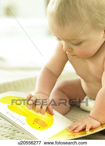 Stock Photo - Baby looking at a book. Fotosearch