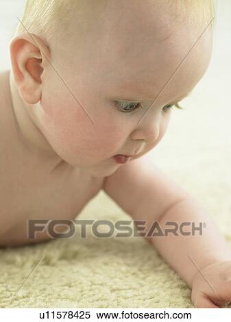 Baby looking down at hand View Large Photo Image Stock Photography - Baby looking down at hand. Fotosearch