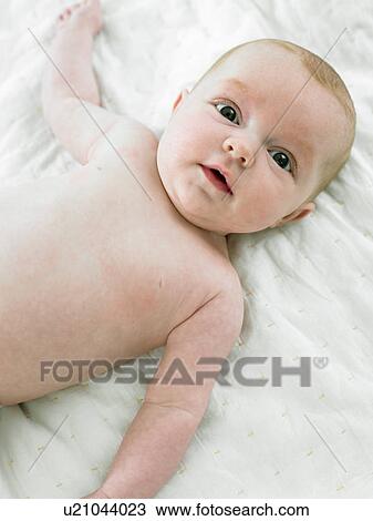 Stock Image - Baby lying on back. Fotosearch