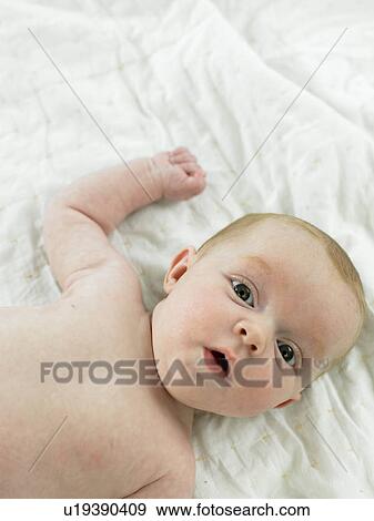 Baby lying on back View Large Photo Image Stock Photo - Baby lying on back. Fotosearch