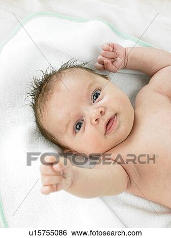 Baby lying on back with hand up View Large Photo Image Stock Photograph - Baby lying on back with hand up. Fotosearch