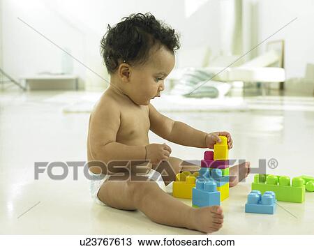 Baby playing with plastic blocks View Large Photo Image Stock Image - Baby playing with plastic blocks. Fotosearch