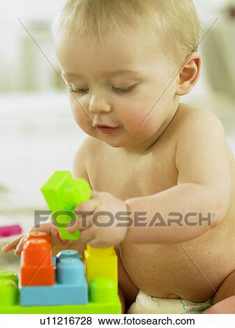 Baby playing with plastic blocks View Large Photo Image Stock Photo - Baby playing with plastic blocks. Fotosearch