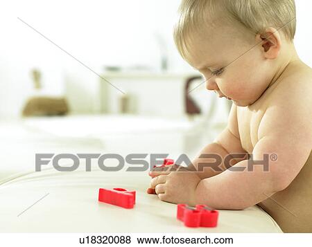 Baby playing with plastic letters View Large Photo Image Stock Photo - Baby playing with plastic letters. Fotosearch